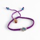 PULSERA MANO DE FATIMA Y OJO TURCO EN MACRAME MORADO CON FOTO